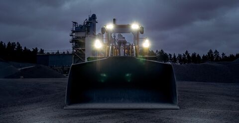Volvo L180 wheel loader at night with lights on