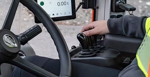 Operator hands on the controls in Volvo L180 wheel loader