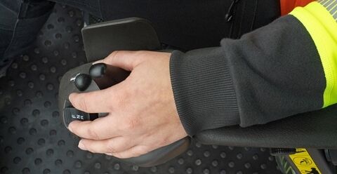 Operator hand controlling comfort drive control lever in Volvo L220 wheel loader