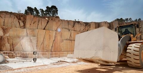 Volvo wheel loader carrying large block working in block handling