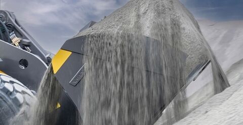 Close up of Volvo wheel loader bucket loading from the pile using auto bucket fill