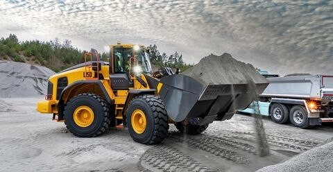Volvo L150 wheel loader with a full bucket of aggregate dust