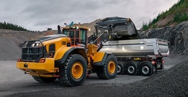 Volvo L180 wheel loader loading a Volvo truck in a quarry