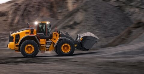 Volvo L180 wheel loader travelling with a full bucket in a quarry Volvo
