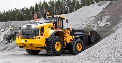 Lights on at the rear of L220 Volvo Wheel Loader as it loads from pile