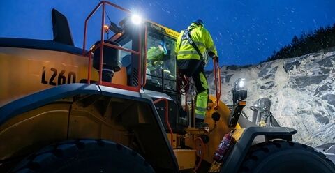Technician standing on new service platform to safely work on Volvo L260 wheel loader