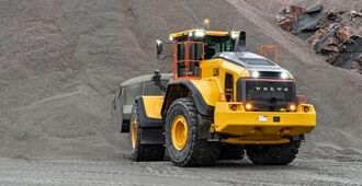 Volvo L260 loading gravels in a quarry with all lights switched on