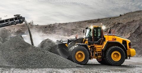 Three large buckets in front of L260 Volvo wheel loader in quarry