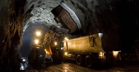 Volvo L260 wheel loader working in tunnel with lights on using side tip bucket