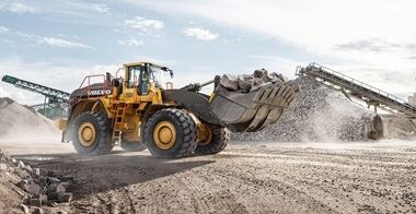 Side view of Volvo L350H fully loaded with rocks in a crushing site.