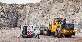 a maintenance technician working on a Volvo L350 loader.