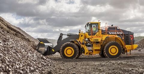 Side  view of the L350H wheel loader fullfilling the bucket with gravels.
