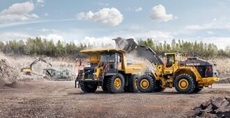 Side view of wheel loader L350H loading a Volvo Rigid dump truck.