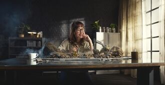 Lady working at desk with all Volvo Construction Equipment smarter solutions working in front of her